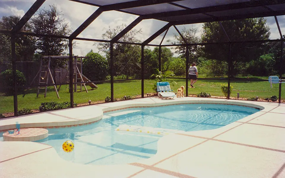 Pool inside a dark-framed screen enclosure